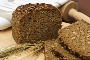whole grain bread and slices with wheat and barley, rolling pin,