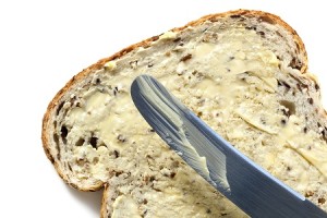 Bread and butter, with knife.  Overhead view, white background. (<a href=