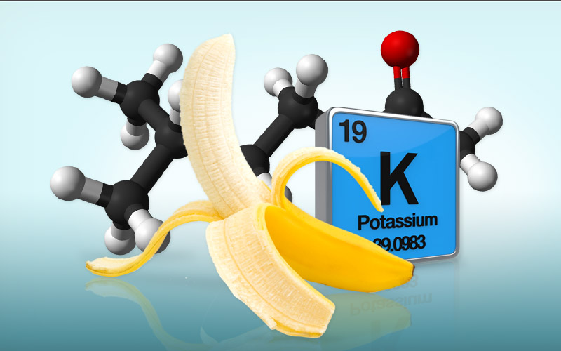 A partially peeled banana in front of the atomic table symbol for potassium and a molecule model behind it all.