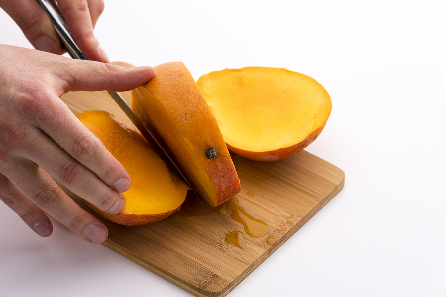 A mango that has been cut into 3 parts