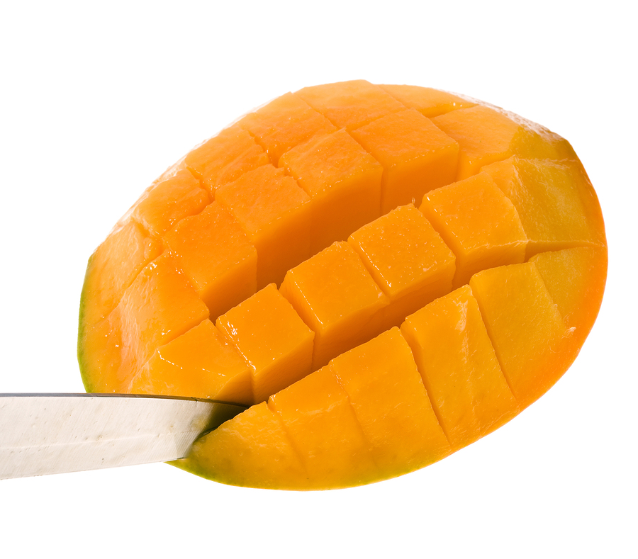A mango slice that has been inverted and has had the flesh cut into cubes