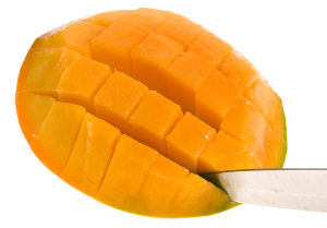 A mango being sliced into cubes