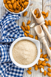 Gluten free Almond flour and dry almond nuts on a wooden table