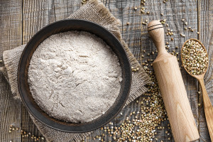 Buckwheat flour in a bowl on a wooden table