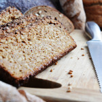 Ezekiel Bread sliced on a wooden cutting board