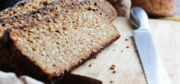 Ezekiel Bread sliced on a wooden cutting board