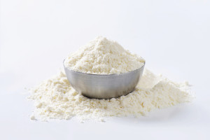 Amaranth flour in a metal bowl on a white background