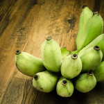 Bunch of Green banana on wooden table