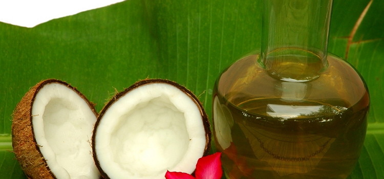 Coconut and coconut oil on a palm leaf with a red flour